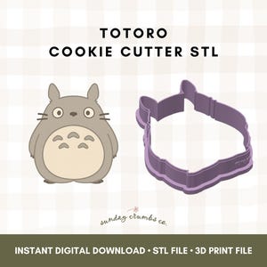May include: An illustration of a Totoro character next to a purple cookie cutter in the shape of Totoro. The text "TOTORO COOKIE CUTTER STL" is at the top. Below is the text "INSTANT DIGITAL DOWNLOAD • STL FILE • 3D PRINT FILE".