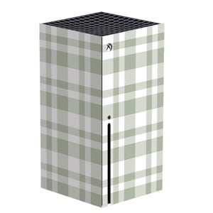 May include: A gaming console with a plaid pattern in shades of gray and white. The console has a black top with a grid design and a vertical black stripe on the side. The Xbox logo is visible on the top corner.