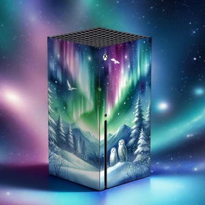 May include: A gaming console featuring a vibrant design of the Northern Lights. The console's exterior showcases a winter landscape with snowy trees, mountains, and owls under a colorful aurora borealis. The top has a black, honeycomb-like pattern.