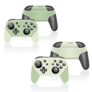 Peut inclure: Quatre manettes de jeu sans fil dans une palette de couleurs vert clair et grise. Les manettes présentent une disposition de boutons classique avec un pavé directionnel, des boutons d'action et des joysticks analogiques. Le design est moderne et épuré.