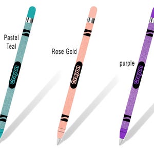 May include: Three Apple Pencil skins with a Crayola crayon design. The skins are in pastel teal, rose gold, and purple.