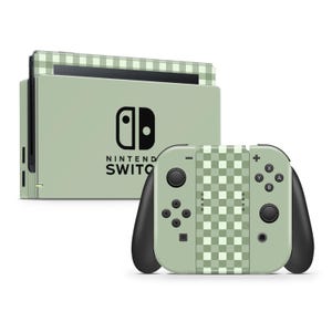 May include: A green and white checkered Nintendo Switch console and controller. The console has the Nintendo Switch logo and the words "Nintendo Switch" printed on it. The controller has a green and white checkered design on the back.