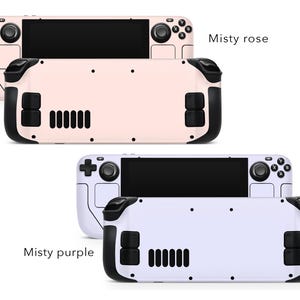 May include: Two handheld gaming consoles, one in a light pink colour with the text "Misty rose" and the other in a light purple colour with the text "Misty purple".
