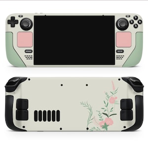 May include: A white and green handheld gaming console with a floral design on the back. The console has a screen, buttons, and a joystick.