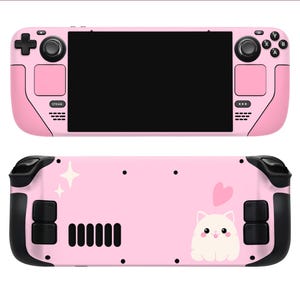 May include: Pink handheld gaming console with a black and white cat illustration on the back. The console has a pink screen and black buttons.