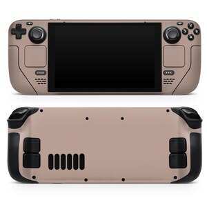 May include: A beige handheld gaming device with black buttons and a black screen. The device has a textured surface and a Steam logo on the front.