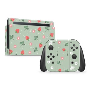 May include: A green Nintendo Switch console and controller with a strawberry and flower pattern.
