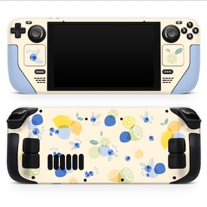 May include: A handheld gaming console featuring a cream-coloured skin with a pattern of yellow lemons, green lime slices, and blue blueberries. The front has light blue accents, while the back displays a repeating fruit print and black vents.