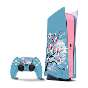 May include: A blue and pink PlayStation 5 console with a floral design featuring cherry blossoms. The console is shown with a matching blue controller.