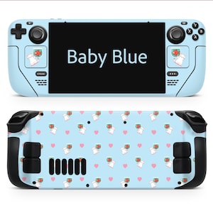 May include: A baby blue handheld gaming console with the text "Baby Blue" on the screen. The console has a cartoon cat and fish design. The back features a repeating pattern of cats, fish, and pink hearts.