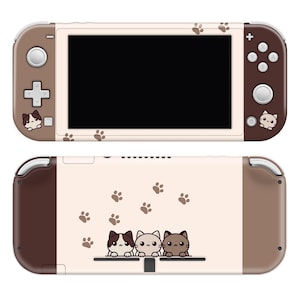May include: A brown and white Nintendo Switch console skin with a design of three cartoon cats and paw prints. The skin is designed to fit the Nintendo Switch console.