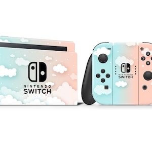 May include: A pink and blue Nintendo Switch console and two controllers with a cloud and sky design. The console and controllers have the Nintendo Switch logo and text.