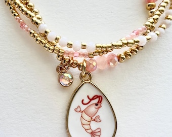 Conjunto de pulseras de oro y coral con diseño de gamba