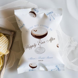 May include: A white paper bag with a blue ribbon design. The bag has a cocktail illustration and the text "A TINI BIT CLOSER TO HAPPILY EVER AFTER" and "Allison's Bridal Shower 08.01.20".