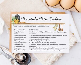 May include: A printable recipe card for chocolate chip cookies with a watercolor illustration of a kitchen scene. The recipe includes ingredients like butter, sugar, flour, eggs, and chocolate chips. The card also includes instructions for baking the cookies.