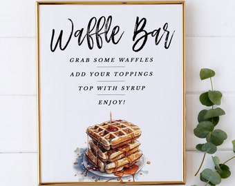 May include: A printable sign for a waffle bar with the text "Waffle Bar" in black script font. The sign also includes the text "Grab some waffles, add your toppings, top with syrup, enjoy!" and a watercolor illustration of a stack of waffles with syrup.