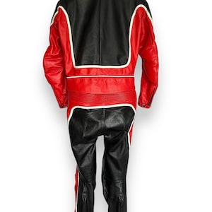 May include: A two-piece motorcycle suit in black and red leather with white accents. The jacket features a black upper back and red sleeves and torso. The pants are black with red and white stripes down the sides. The suit has zippers on the sleeves and legs.
