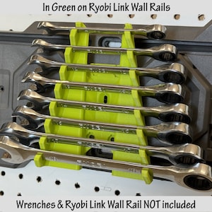 May include: Green plastic wrench holders for a Ryobi Link wall rail system. The holders are designed to hold wrenches vertically. The text "Wrenches & Ryobi Link Wall Rail NOT included" is visible at the bottom of the image.