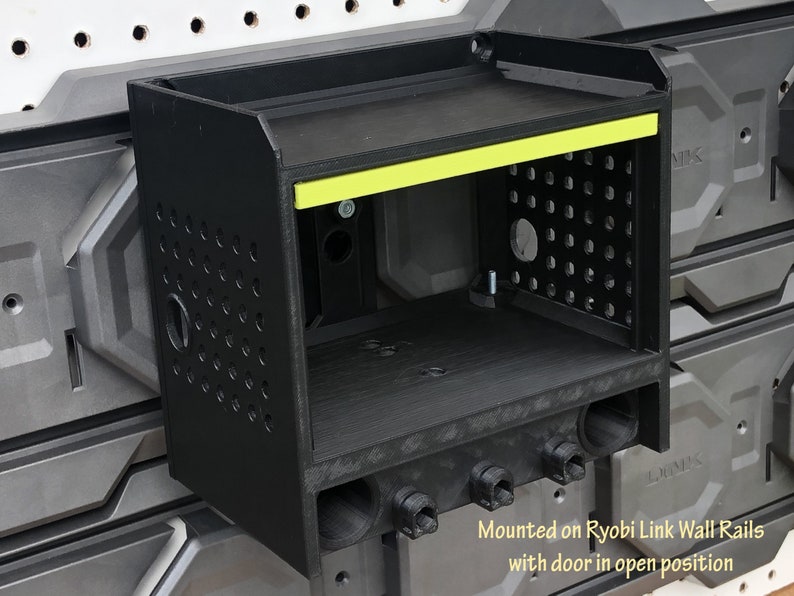 May include: Black wall-mounted storage unit with a yellow accent strip and a door open. The unit is mounted on Ryobi Link Wall Rails. "Mounted on Ryobi Link Wall Rails with door in open position" is written below the unit.