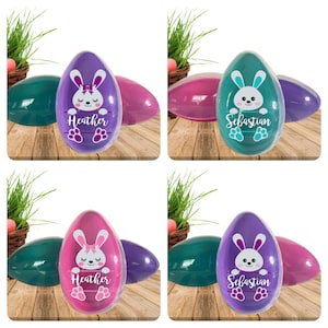 May include: Four plastic Easter eggs with bunny designs. Two eggs are purple with a white bunny and the text "Heather". Two eggs are teal with a white bunny and the text "Sebastian".