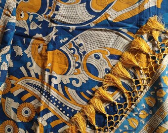 May include: A blue and white cotton fabric with a yellow and white paisley pattern. The fabric has a gold tassel trim.