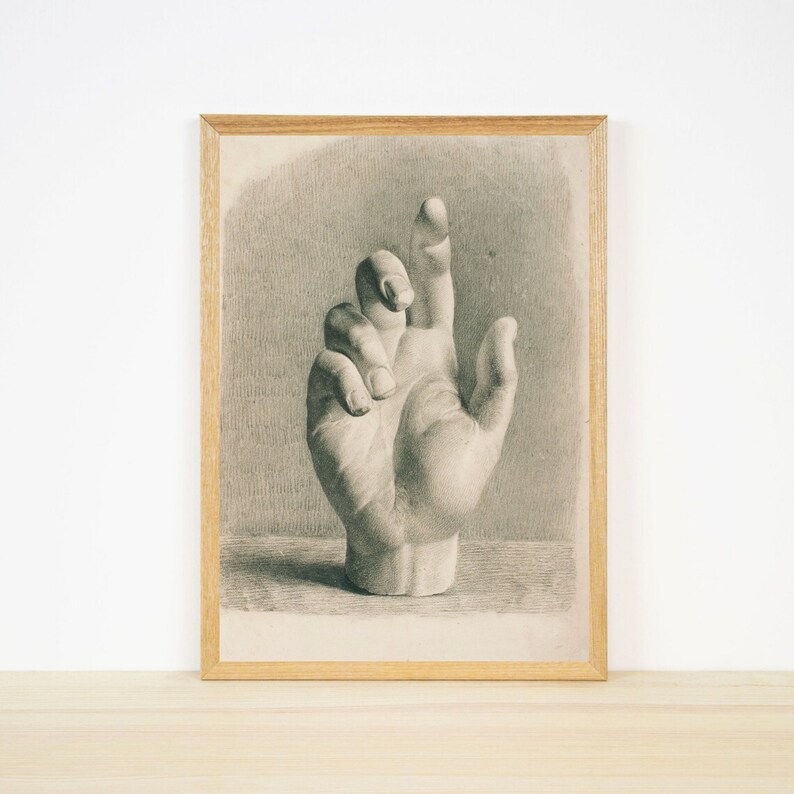 May include: A black and white drawing of a hand in a vintage style frame.