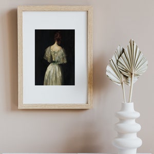 May include: A framed painting of a woman in a white dress with a green sash, standing with her back to the viewer. The painting is set against a dark background.