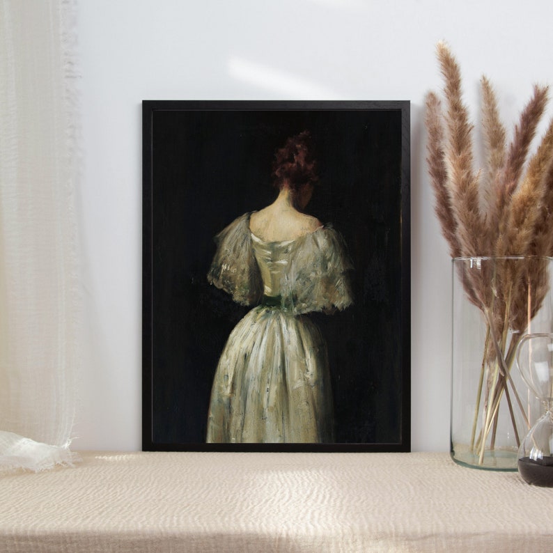 May include: A painting of a woman in a white dress with a green sash, standing with her back to the viewer. The woman has dark hair and is wearing a white dress with a green sash. The painting is set against a dark background.