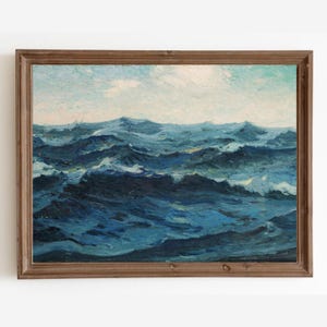 May include: A framed painting depicting a seascape with blue and white waves crashing in the ocean. The sky is a light blue with white clouds.