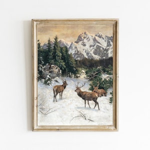 May include: A vintage oil painting depicting a snowy mountain landscape with three deer in the foreground. The mountains are snow-capped and the sky is a soft orange and yellow.