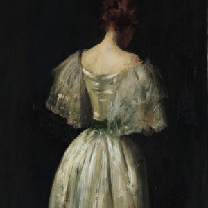 May include: A woman in a white dress with a lace overlay and a green sash stands with her back to the viewer. The dress is flowing and the woman's hair is pulled back.