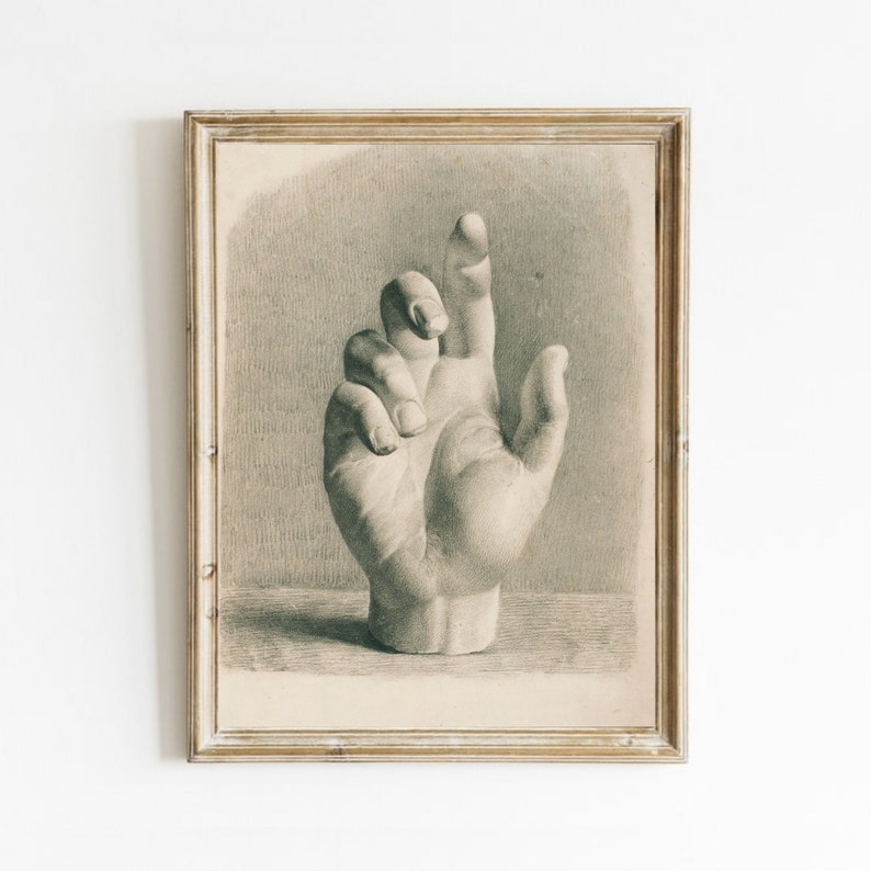 May include: A black and white drawing of a hand, framed in a vintage style. The hand is depicted realistically, with detailed shading and lines.