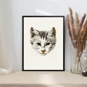 May include: A black and white illustration of a cat's face. The cat has gray fur with white markings and a black nose. The illustration is framed in a black frame.