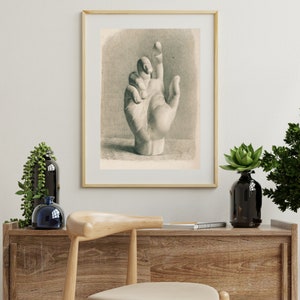 May include: A black and white drawing of a hand with the index finger pointing up. The hand is drawn in a realistic style and appears to be a plaster cast.