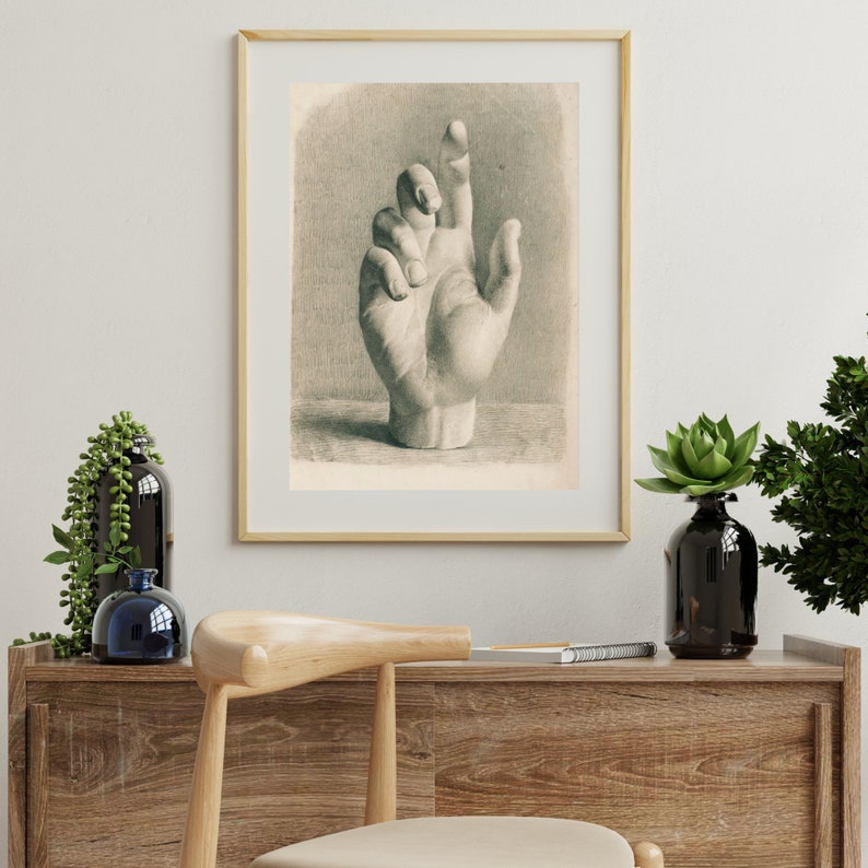 May include: A black and white drawing of a hand with the index finger pointing up. The hand is drawn in a realistic style and appears to be a plaster cast.