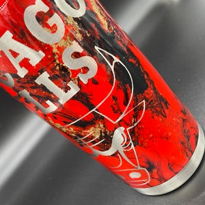 May include: A red, black, and gold stainless steel tumbler with a black bull's head design and the text "Chicago Bulls" engraved on the side.