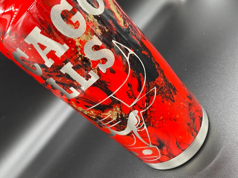 May include: A red, black, and gold stainless steel tumbler with a black bull's head design and the text "Chicago Bulls" engraved on the side.