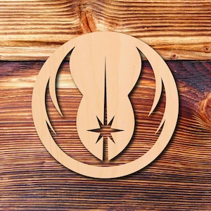 May include: A wooden cutout of the Rebel Alliance symbol from Star Wars. The symbol features a white star inside a circle with two curved lines on either side.