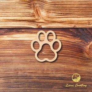 May include: A wooden paw print cutout on a brown wood background.