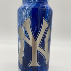 May include: A blue and white marbled stainless steel tumbler with a silver NY logo.