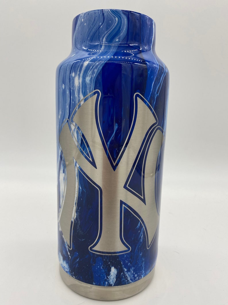 May include: A blue and white marbled stainless steel tumbler with a silver NY logo.