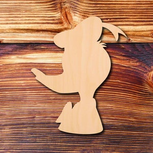 May include: A wooden cutout of a cartoon character with a large nose and a hat. The cutout is light brown and is placed on a brown wooden background.