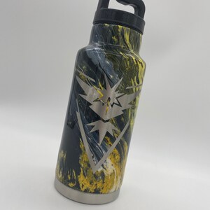 May include: A black and yellow marbled stainless steel water bottle with a black handle and a silver engraved logo of a bird with a lightning bolt.