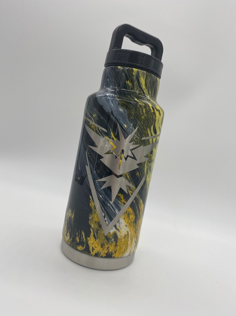 May include: A black and yellow marbled stainless steel water bottle with a black handle and a silver engraved logo of a bird with a lightning bolt.