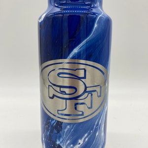 May include: A blue and white marbled stainless steel tumbler with a silver SF logo.