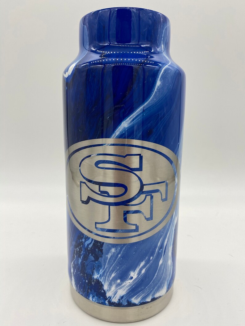 May include: A blue and white marbled stainless steel tumbler with a silver SF logo.