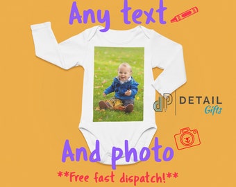May include: White long-sleeve baby onesie with a photo of a baby boy sitting on a bed of leaves. The onesie has the text "Any text" and "And photo" printed on it. The text "Free fast dispatch!" is also printed on the onesie.