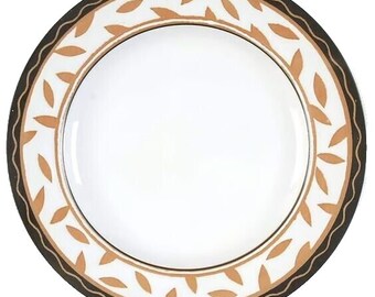 May include: A white ceramic dinner plate with a black and gold rim and a pattern of gold leaves.