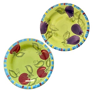 May include: Two ceramic salad bowls with green backgrounds and colorful trim. One bowl features painted red tomatoes and green leaves, while the other features painted purple eggplants and green leaves.