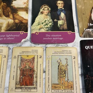 May include: A set of tarot cards with colorful illustrations and text. The cards are arranged in a grid with the top row showing the cards "Flirt", "Wedding", and "Daydream". The bottom row shows the cards "Justice", "Page of Wands", and "Queen of Swords".